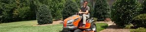 Man using Husqvarna lawn tractor