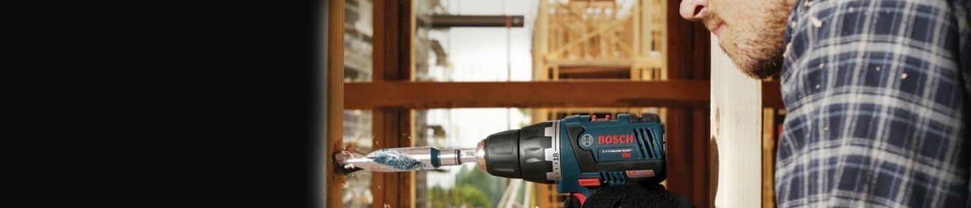 Man drilling a wall with power drill