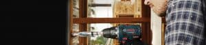Man drilling a wall with power drill